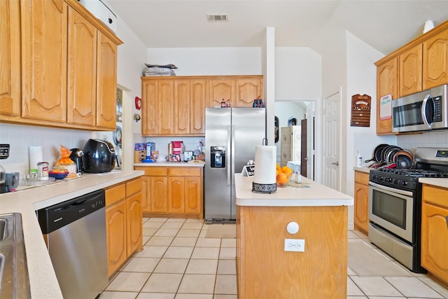 5000 Coral Creek Dr, Fort Worth, TX 76135 - kitchen with appliances with stainless steel finishes, decorative backsplash, light tile patterned flooring, and light countertops