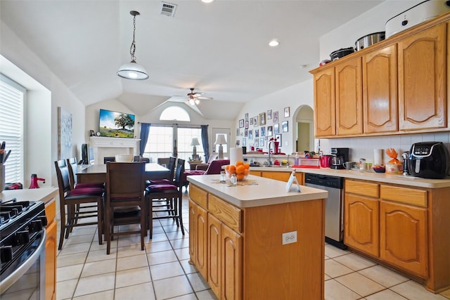 5000 Coral Creek Dr, Fort Worth, TX 76135 - kitchen with appliances with stainless steel finishes, ceiling fan, light countertops, a kitchen island, and light tile patterned floors