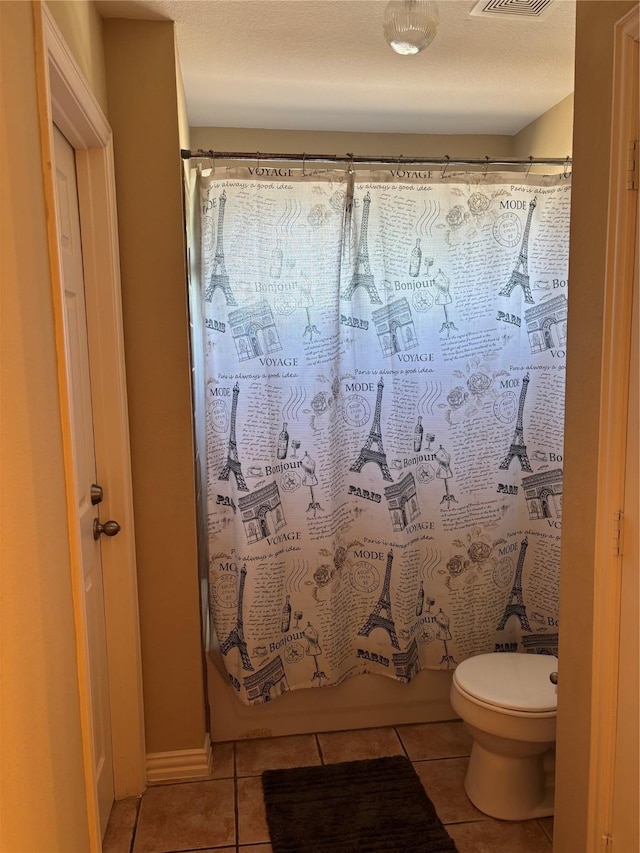 1435 Delta Dr, Cedar Hill, TX 75104 - bathroom featuring tile patterned floors, toilet, and shower / bath combination with curtain