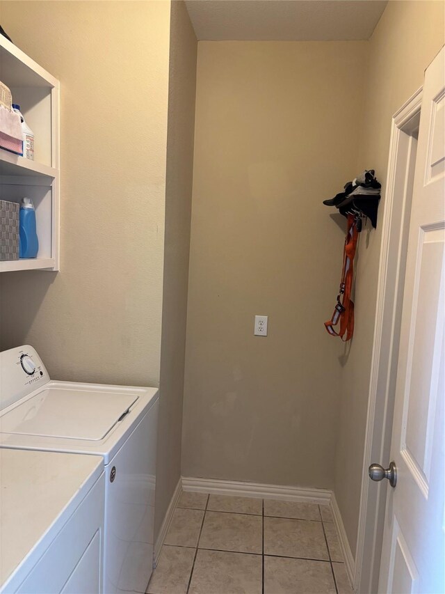 1435 Delta Dr, Cedar Hill, TX 75104 - laundry room with washer and dryer, light tile patterned floors, and baseboards