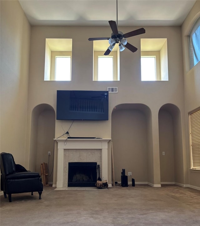 1435 Delta Dr, Cedar Hill, TX 75104 - unfurnished living room with a high ceiling, carpet, a ceiling fan, a fireplace, and baseboards