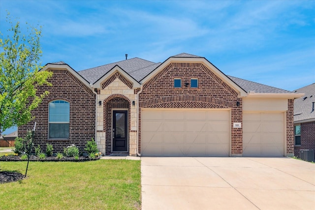 501 Nolan Way, Little Elm, TX 75068 - french provincial home featuring brick siding, a garage, concrete driveway, a front lawn, and stone siding