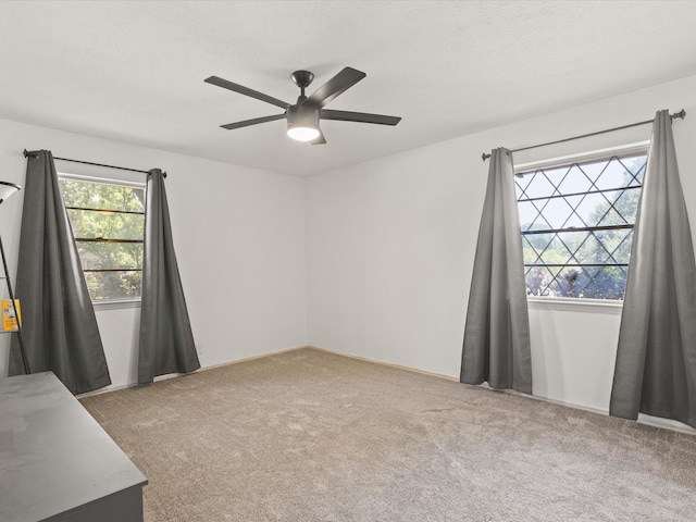 carpeted empty room with ceiling fan
