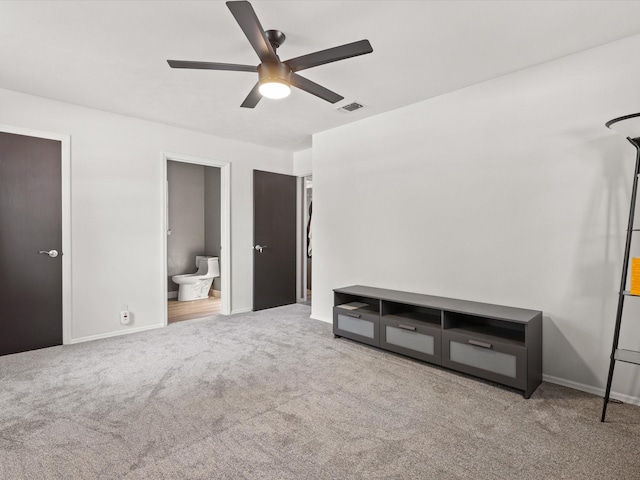 unfurnished bedroom featuring carpet floors, baseboards, a ceiling fan, and ensuite bathroom
