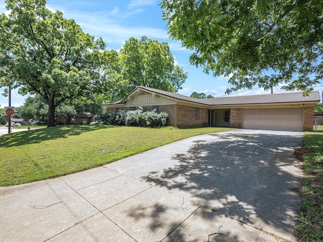 view of front of property featuring a garage, brick siding, concrete driveway, and a front lawn