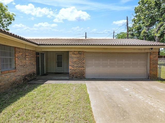 single story home with a garage, brick siding, driveway, and a tile roof