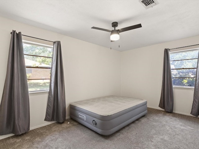 carpeted bedroom with baseboards and ceiling fan