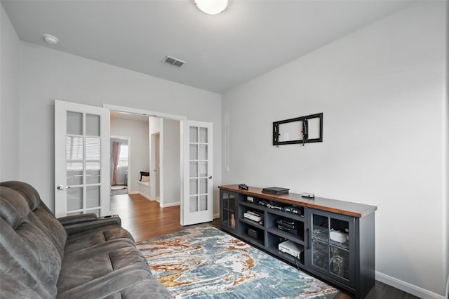 3812 Wheatland Trl, Forney, TX 75126 - living room featuring french doors, wood finished floors, and baseboards