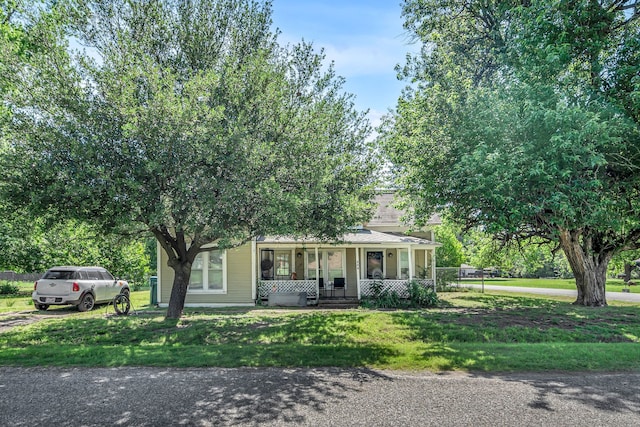 209 S Britton St, Tom Bean, TX 75489 - obstructed view of property featuring a porch and a front lawn