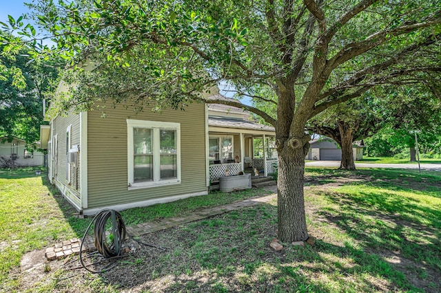 209 S Britton St, Tom Bean, TX 75489 - view of front of property with covered porch, a front yard, and a detached garage
