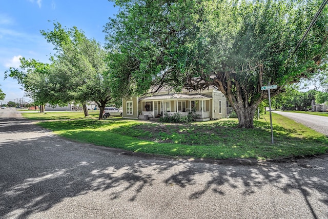 209 S Britton St, Tom Bean, TX 75489 - view of front of property with a porch and a front lawn
