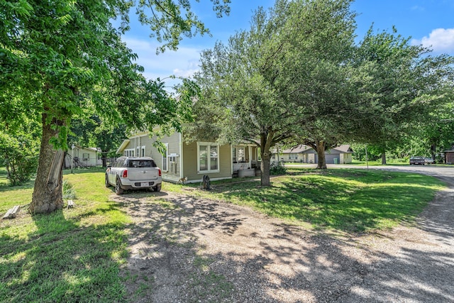 209 S Britton St, Tom Bean, TX 75489 - obstructed view of property featuring a front lawn and dirt driveway