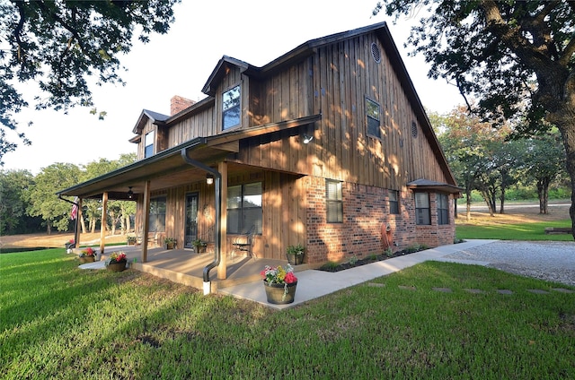 701 Elmhill Blvd, Burleson, TX 76028 - view of side of property featuring brick siding, a yard, a patio area, a chimney, and board and batten siding