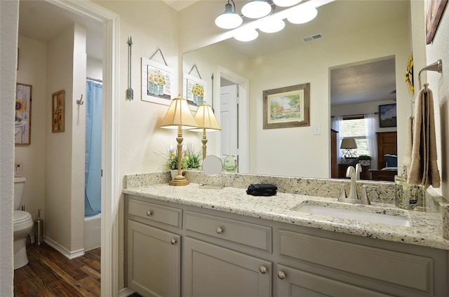 701 Elmhill Blvd, Burleson, TX 76028 - full bathroom with wood finished floors, vanity, toilet, baseboards, and shower / bath combo with shower curtain