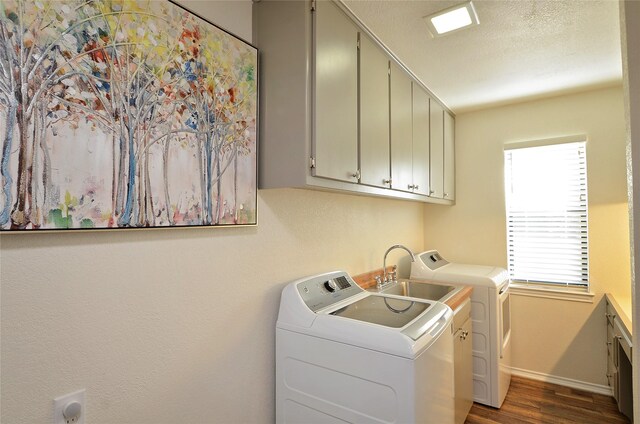 701 Elmhill Blvd, Burleson, TX 76028 - clothes washing area with cabinet space, washer and clothes dryer, dark wood-type flooring, and baseboards