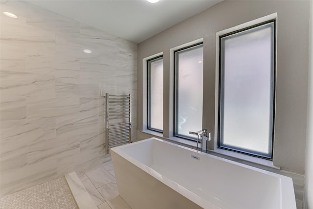 3326 Courtyard Pl, Farmers Branch, TX 75234 - full bathroom featuring marble look tiles, a freestanding bath, a towel warmer, and radiator