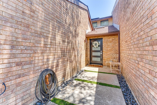 3326 Courtyard Pl, Farmers Branch, TX 75234 - entrance to property with a shingled roof, brick siding, and a patio area