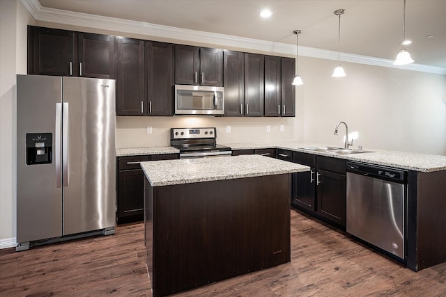 101 Springtree St, Denton, TX 76209 - kitchen with appliances with stainless steel finishes, a sink, ornamental molding, a peninsula, and dark wood-style flooring