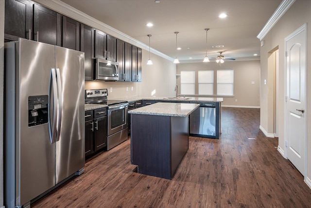 101 Springtree St, Denton, TX 76209 - kitchen with appliances with stainless steel finishes, a peninsula, a sink, ornamental molding, and ceiling fan