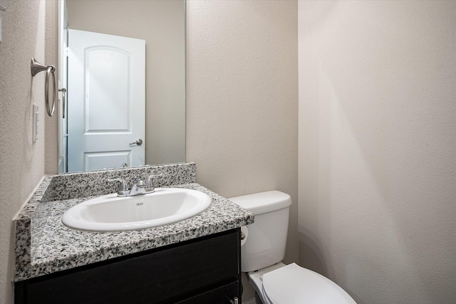 101 Springtree St, Denton, TX 76209 - half bath with toilet, vanity, and a textured wall