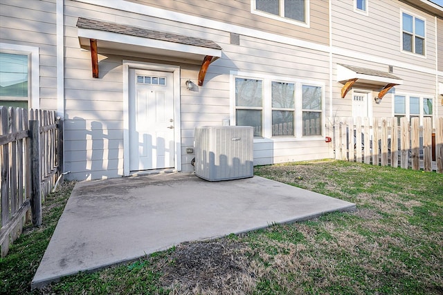 101 Springtree St, Denton, TX 76209 - view of exterior entry with central AC, a patio, and fence