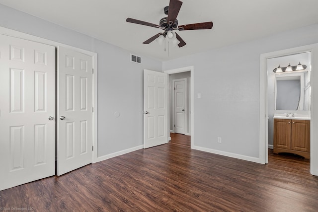 2409 Klondike Dr, Dallas, TX 75228 - unfurnished bedroom with dark wood-type flooring, baseboards, a sink, and a closet