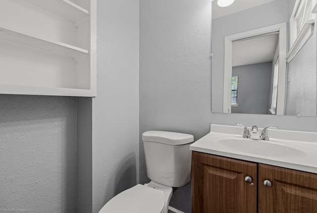 2409 Klondike Dr, Dallas, TX 75228 - bathroom with toilet, vanity, and a textured wall
