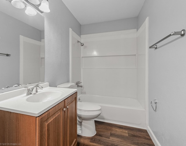 2409 Klondike Dr, Dallas, TX 75228 - full bath with toilet, wood finished floors, shower / tub combination, vanity, and a textured wall