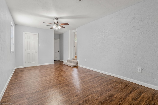 2409 Klondike Dr, Dallas, TX 75228 - empty room featuring dark wood-type flooring, a ceiling fan, a textured wall, and baseboards