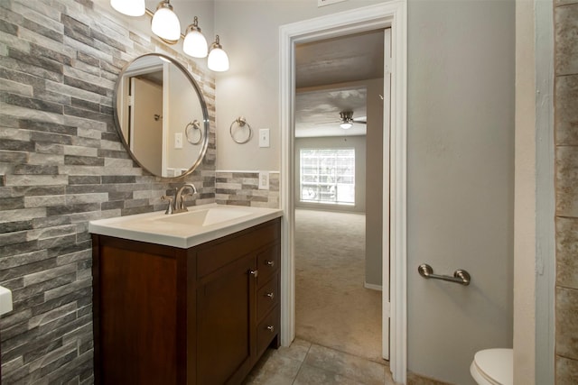 10578 High Hollows Dr Unit 269, Dallas, TX 75230 - bathroom featuring vanity, ceiling fan, tile patterned flooring, and toilet