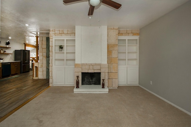 10578 High Hollows Dr Unit 269, Dallas, TX 75230 - unfurnished living room with a ceiling fan, a fireplace, baseboards, and dark colored carpet