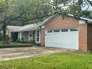 5728 Rockhill Rd, Fort Worth, TX 76112 - single story home featuring a garage, brick siding, and driveway