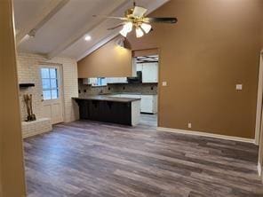 5728 Rockhill Rd, Fort Worth, TX 76112 - kitchen with wood finished floors, ceiling fan, baseboards, a peninsula, and a kitchen breakfast bar