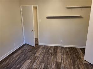 5728 Rockhill Rd, Fort Worth, TX 76112 - unfurnished bedroom featuring wood finished floors and baseboards
