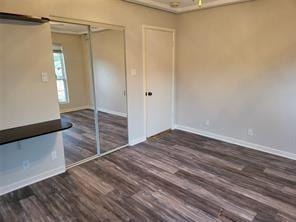 5728 Rockhill Rd, Fort Worth, TX 76112 - unfurnished bedroom featuring wood finished floors and baseboards