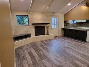 5728 Rockhill Rd, Fort Worth, TX 76112 - unfurnished living room featuring a brick fireplace, wood finished floors, and beam ceiling