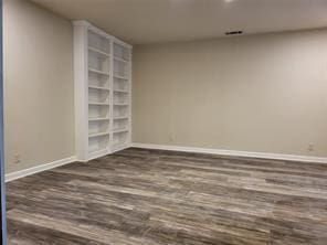 5728 Rockhill Rd, Fort Worth, TX 76112 - spare room with wood finished floors and baseboards