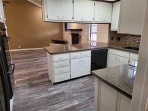 5728 Rockhill Rd, Fort Worth, TX 76112 - kitchen with dishwasher, a peninsula, dark wood-style flooring, white cabinets, and backsplash