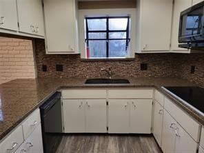 5728 Rockhill Rd, Fort Worth, TX 76112 - kitchen featuring black appliances, white cabinetry, wood finished floors, a sink, and tasteful backsplash