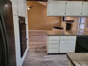 5728 Rockhill Rd, Fort Worth, TX 76112 - kitchen featuring black appliances, wood finished floors, white cabinetry, baseboards, and light countertops