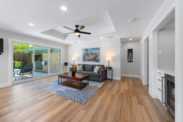 15732 Nedra Way, Dallas, TX 75248 - living area featuring a raised ceiling, light wood-style flooring, a ceiling fan, baseboards, and recessed lighting