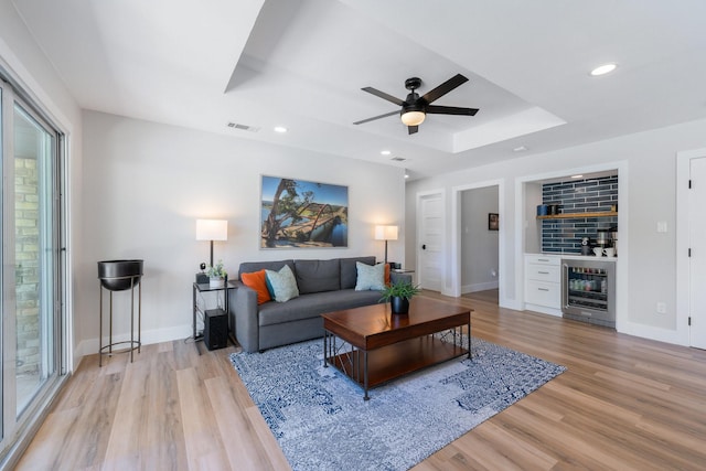 15732 Nedra Way, Dallas, TX 75248 - living area with a raised ceiling, light wood-style floors, ceiling fan, baseboards, and recessed lighting