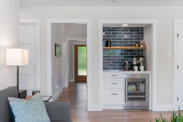 15732 Nedra Way, Dallas, TX 75248 - indoor dry bar featuring beverage cooler, wood finished floors, and baseboards