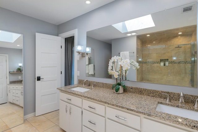 15732 Nedra Way, Dallas, TX 75248 - full bath featuring a skylight, a shower stall, tile patterned floors, and double vanity