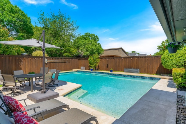 15732 Nedra Way, Dallas, TX 75248 - view of swimming pool with a patio, a fenced backyard, and outdoor dining area