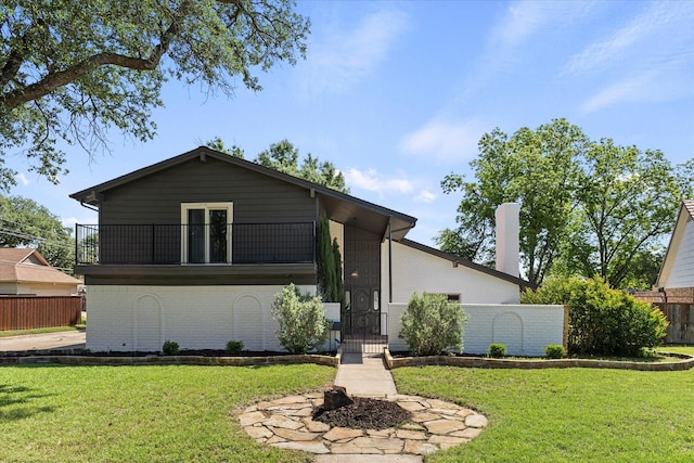 11230 Cotillion Dr, Dallas, TX 75228 - view of front of home featuring a balcony, brick siding, a gate, and an outdoor fire pit