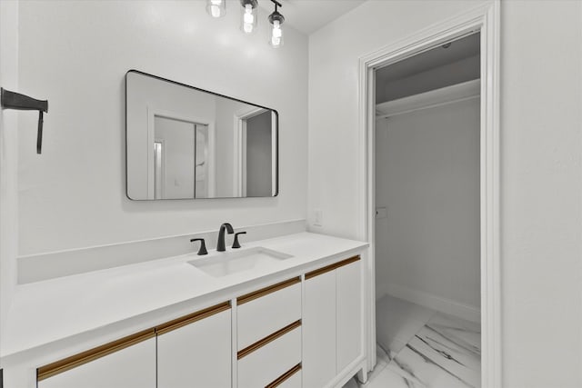 11230 Cotillion Dr, Dallas, TX 75228 - bathroom featuring marble finish flooring, vanity, and baseboards