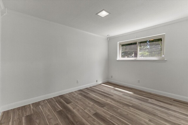 11230 Cotillion Dr, Dallas, TX 75228 - spare room featuring ornamental molding, wood finished floors, and baseboards