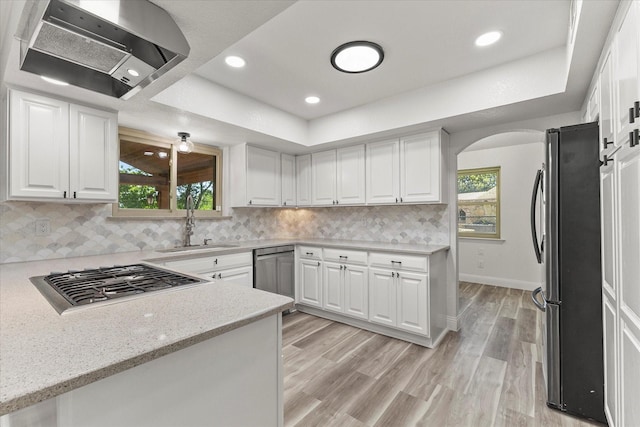 11230 Cotillion Dr, Dallas, TX 75228 - kitchen featuring stainless steel appliances, a sink, plenty of natural light, wall chimney exhaust hood, and recessed lighting