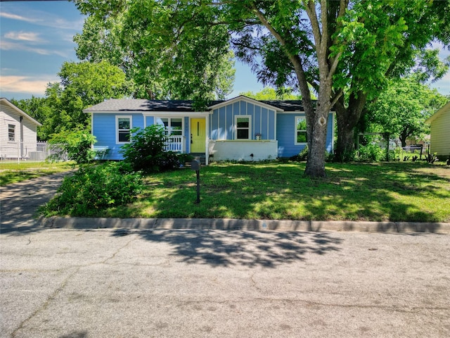 505 E 4th St, Weatherford, TX 76086 - view of front of property featuring a front lawn, board and batten siding, and covered porch